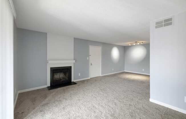 Living room with a fireplace and white carpet  at Governors House, Alabama, 35805