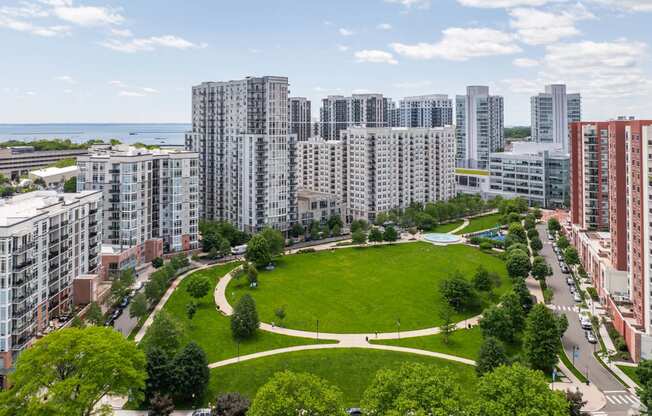 an aerial view of a park in a city with tall buildings