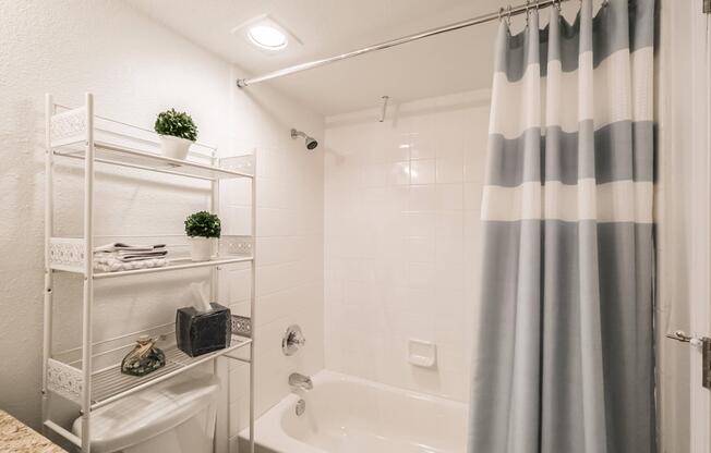 a shower curtain next to a sink