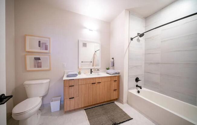 a bathroom with a toilet sink and a shower