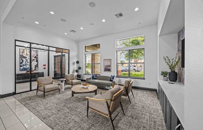 A spacious waiting room with a grey carpet and wooden furniture.