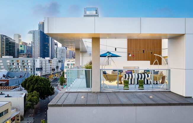 South Park, Los Angeles CA Apartments For Rent - Emerald - An Open Air Rooftop Lounge Area With Stylish Seating Overlooking A City Skyline