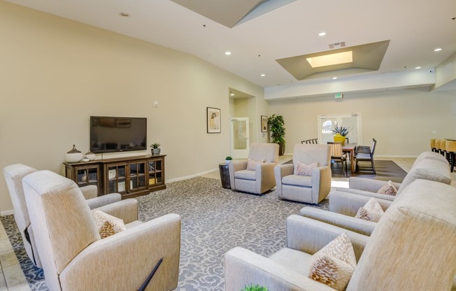 a living room filled with furniture and a flat screen tv