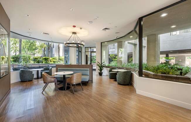 a large room with tables and chairs and large windows