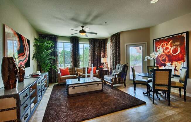 Apartments for Rent in Chandler - Monument - Spacious Living Room with Wood-Style Flooring, Ceiling Fan, and Large Windows