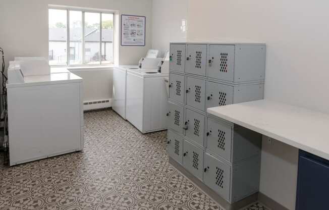 a room with white cabinets and a window