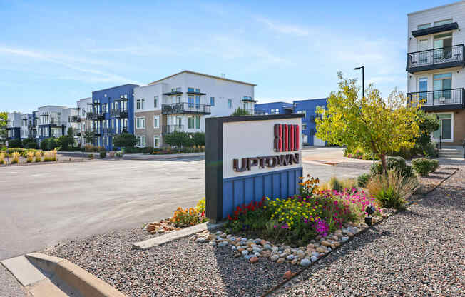 A sign that says "UPTOWN" is in front of some buildings.