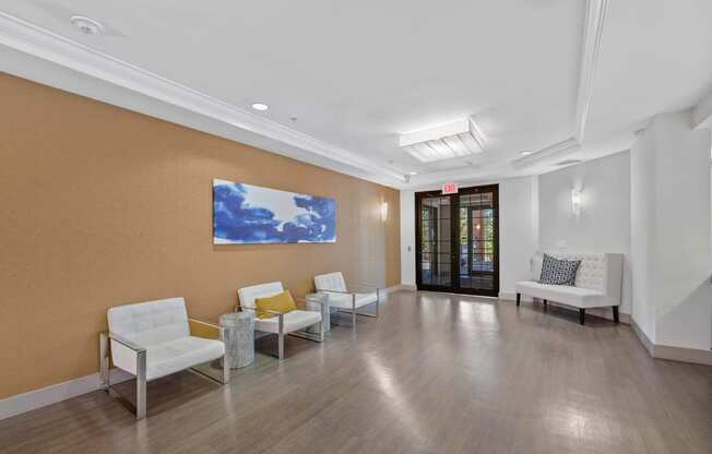 a waiting room with white chairs and a blue painting on the wall  at The Lena, Raritan, NJ, 08869