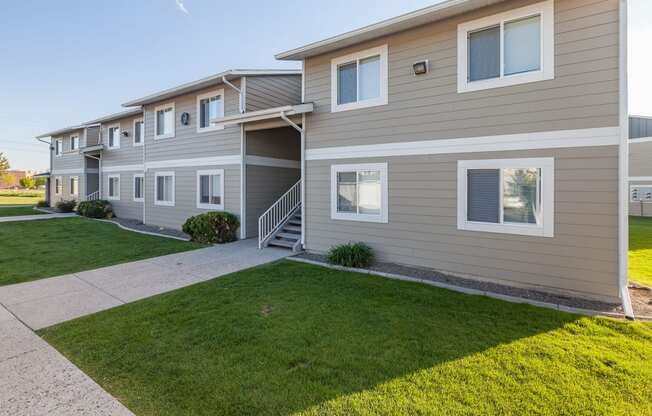 a sidewalk in front of a building with grass at Shiloh Glen, Billings Montana