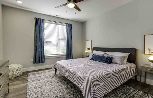 a bedroom with a bed and a ceiling fan at Echo Park at Perry Crossing Apartments, Plainfield, 46168