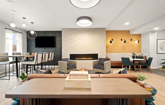 a living room with a fireplace and a table with chairs