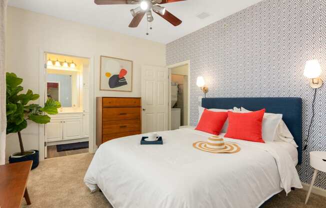 a bedroom with a large bed and a ceiling fan at Residences at Stevens Pond, Saugus