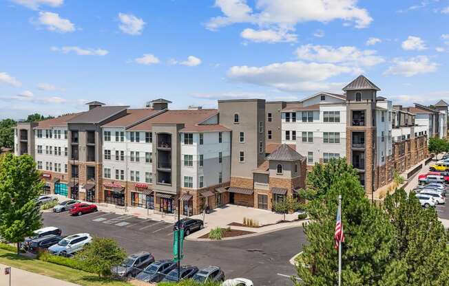 an aerial view of an apartment complex with a parking lot