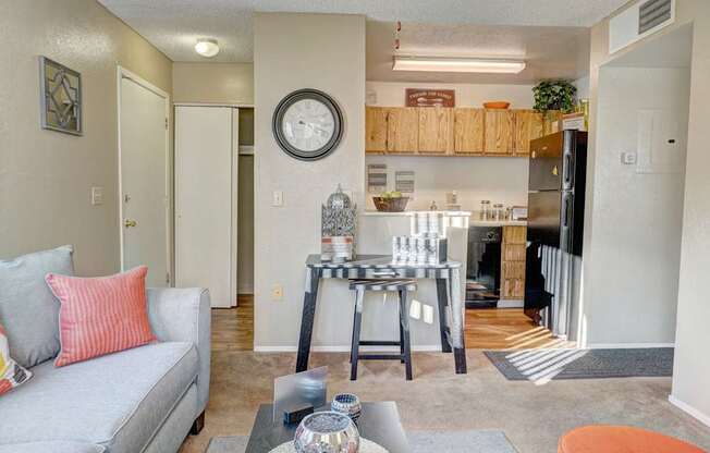 A living room with a grey couch and a coffee table.