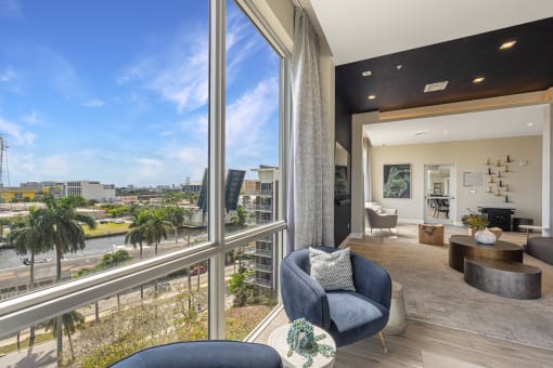 a living room with large windows and a view of the city