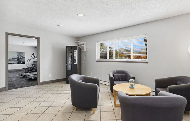 a living room with chairs and a table