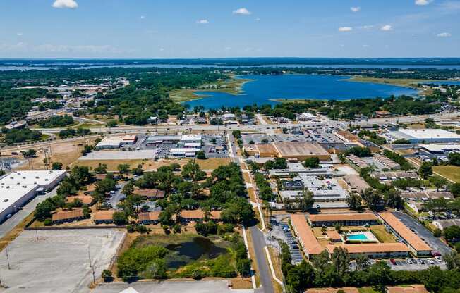 A large industrial area with a lake in the distance.