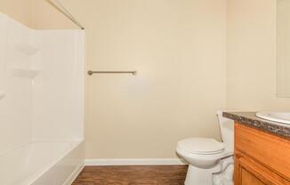 a white tub sitting next to a shower