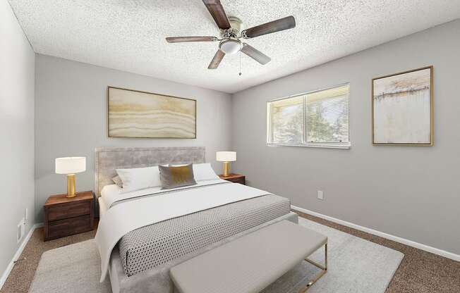 a bedroom with a bed and a ceiling fan