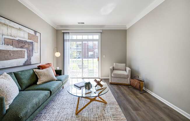 A living room with a green couch and a coffee table.