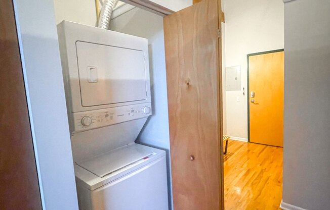 a walk in closet with a washer and dryer in a apartment