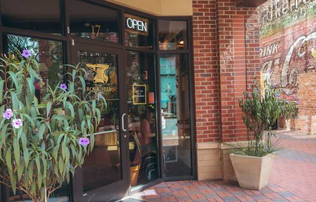 the front entrance of crave restaurant with glass doors