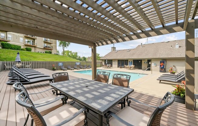 A wooden table and chairs are set up on a patio.
