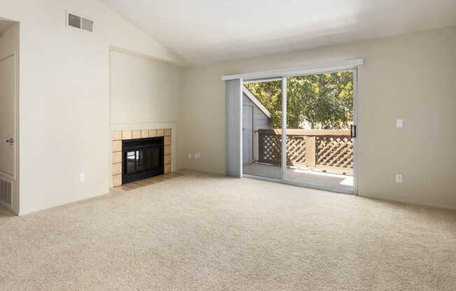 Carpeted Living Room with Fireplace and Balcony