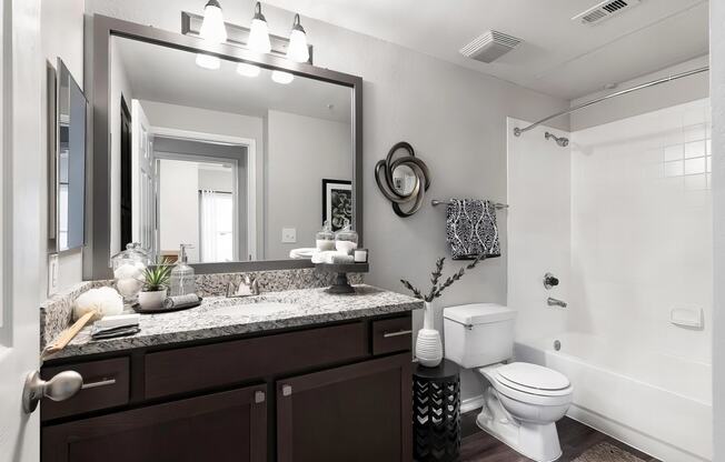 Mesa Verde Bathroom Upgraded Bathroom with Granite Vanity Framed Mirror Curved Shower Curtain Rod