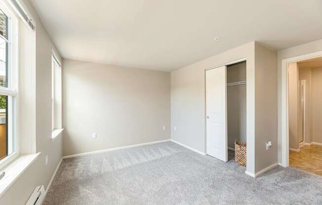 A room with a carpeted floor and a white door.
