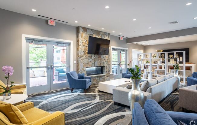 a living room with couches and chairs and a television