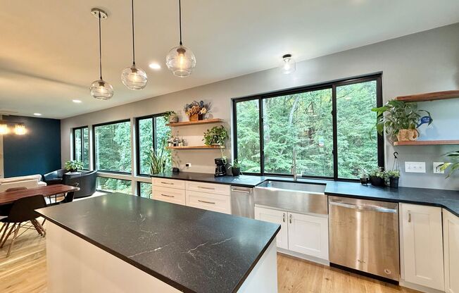 Incredible 5BD, 4.5BA Wake Forest Home Near Falls Lake with a Fully Finished Basement Living Space and a Backyard Haven Including a Large Deck, Fire Pit, and Creek