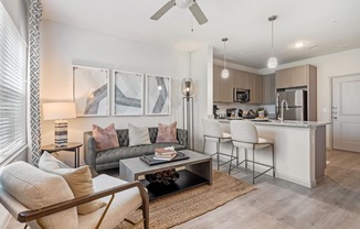 a living room and kitchen with a couch and a table