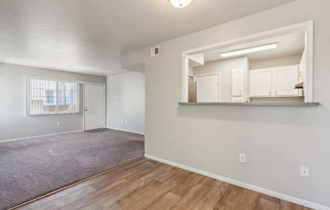 the spacious living room and dining room of an apartment