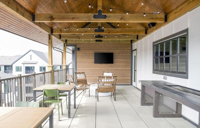 Social elevated outdoor space with seating and string lights at Novel Cary