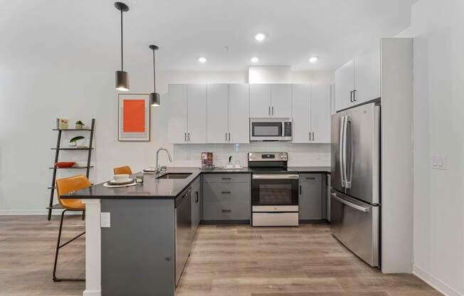 A modern kitchen with a wooden floor and stainless steel appliances.at 829 Garfield, Jersey City New Jersey