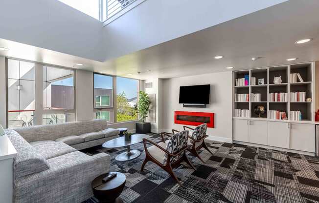 a living room with couches and chairs and a television