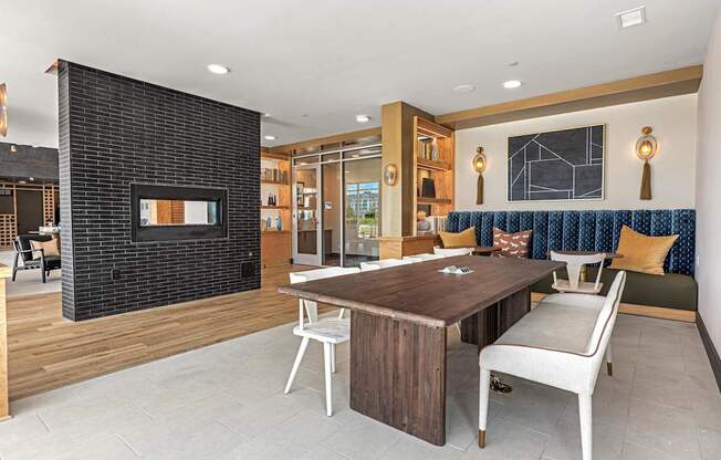 A modern living room with a fireplace and a dining table.