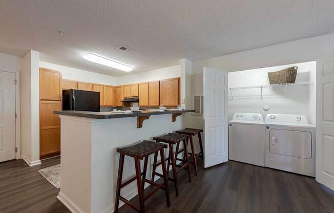 A kitchen with a white fridge and wooden cabinets.