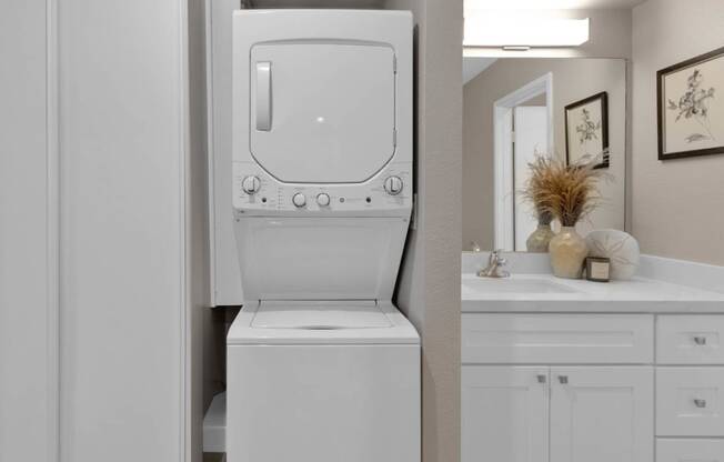 a white washer and dryer in a bathroom