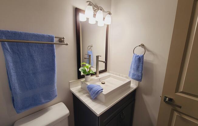a bathroom with sink and towel bars