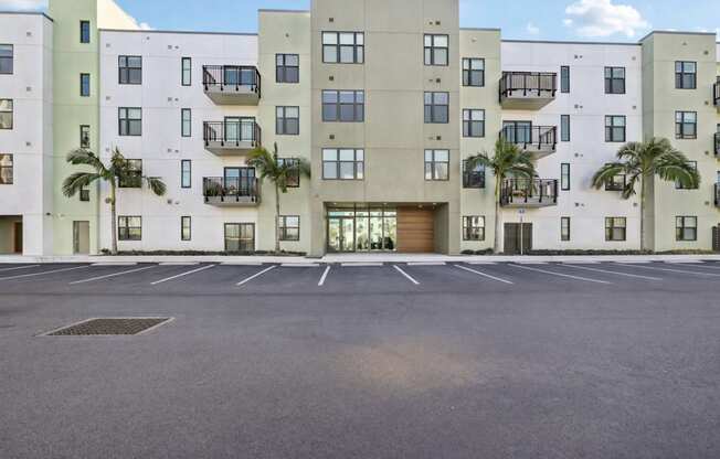 A large building with a parking lot in front of it.