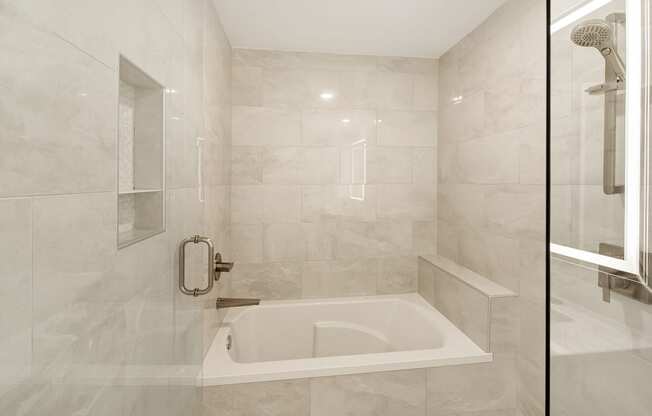 the ensuite bathroom has a tub and a shower at The Azul Apartment Homes, Oxford, Mississippi
