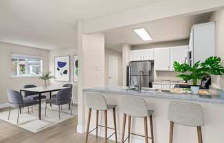 an open kitchen and dining room with a table and chairs