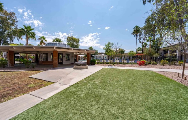 A building with a green lawn in front of it.