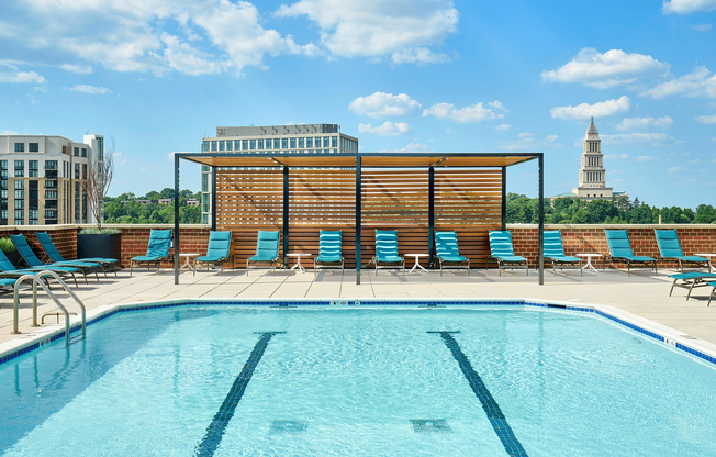 Soak up the sun at our newly renovated pool, featuring a shaded trellis, comfortable chaise lounges, and poolside dining tables.