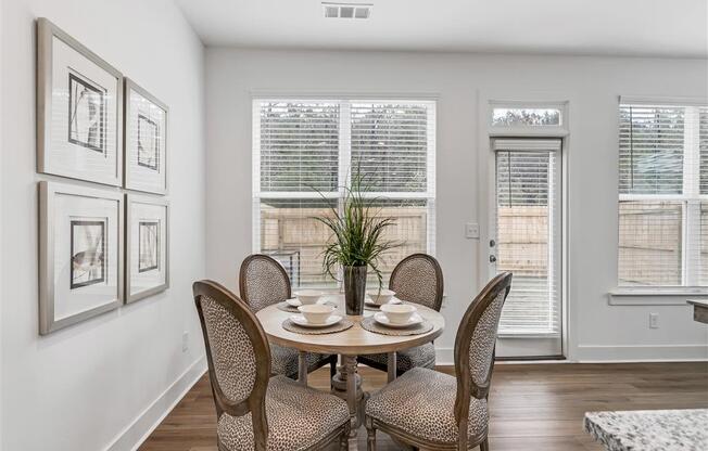 a dining room with a table and chairs