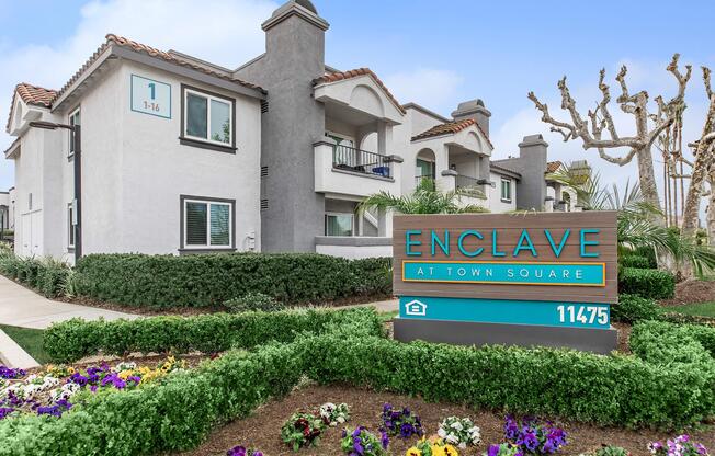 a colorful flower garden in front of a house