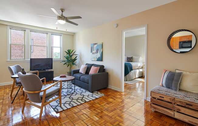 a living room with a couch and a chair and a tv