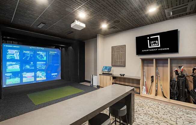 A room with a screen displaying information and a sign that says "Apartment Homes".